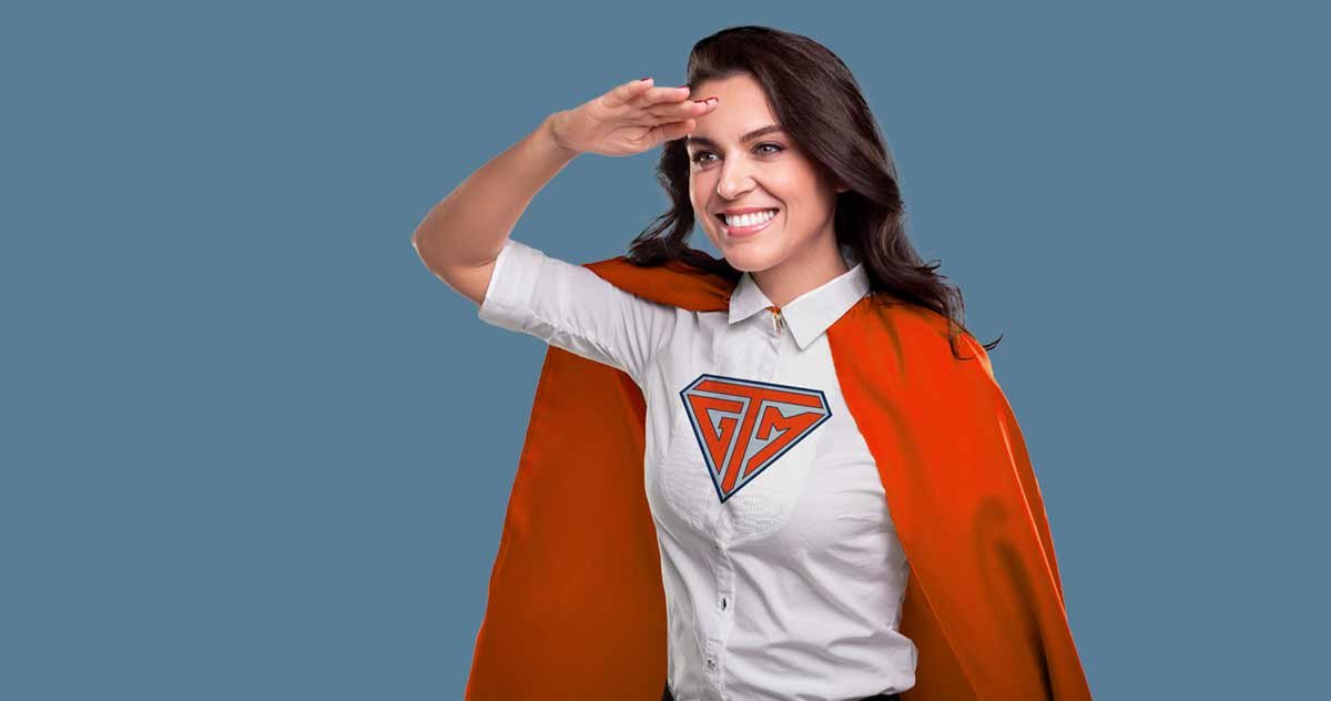 Woman with cape and GTM logo on shirt
